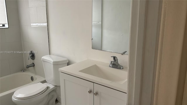 full bathroom with vanity, toilet, and tiled shower / bath combo