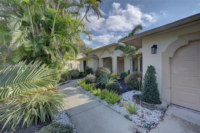 exterior space with stucco siding and a garage