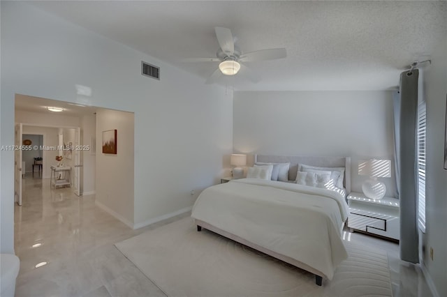 bedroom featuring visible vents, a textured ceiling, baseboards, and a ceiling fan