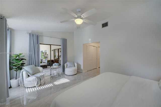 bedroom with lofted ceiling, visible vents, and ceiling fan