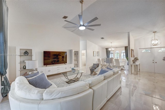 living room featuring built in features, lofted ceiling, ceiling fan with notable chandelier, marble finish floor, and a textured ceiling