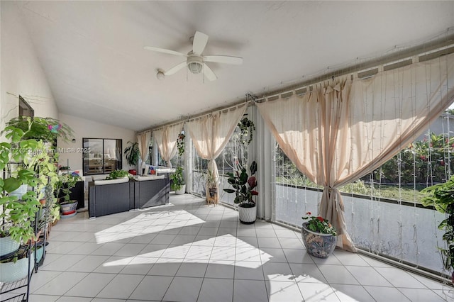 sunroom featuring vaulted ceiling and ceiling fan