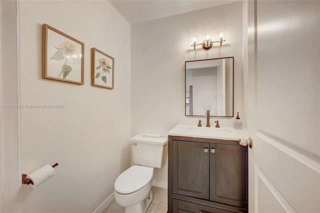 bathroom with vanity, toilet, and baseboards