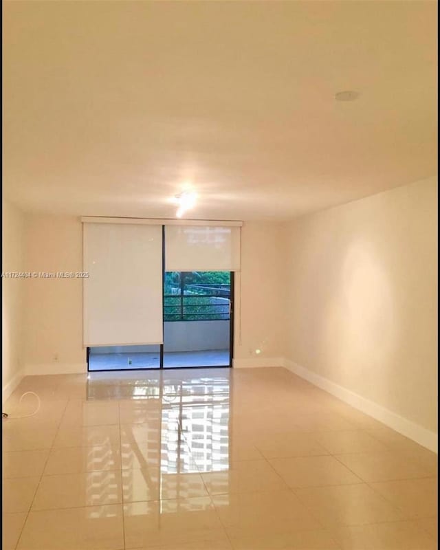 spare room featuring tile patterned flooring