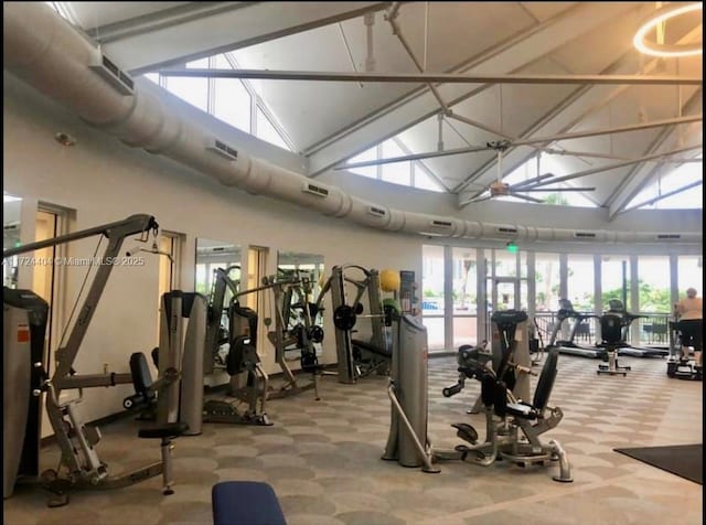 workout area with carpet flooring and high vaulted ceiling