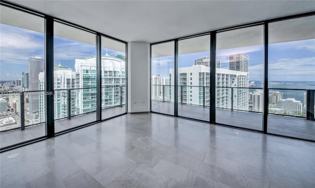 empty room featuring a wall of windows and a city view