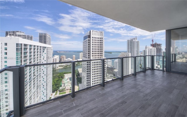 balcony featuring a view of city and a water view