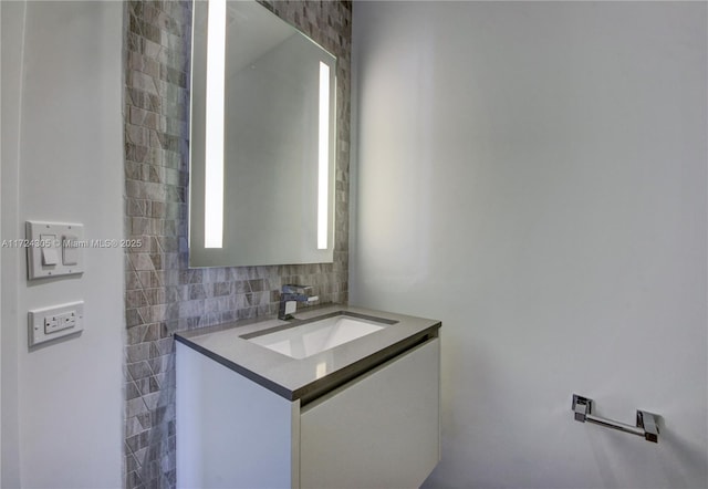 68 SE 6th St Unit 3511, Miami, FL 33131 - bathroom featuring vanity, tile walls, and decorative backsplash