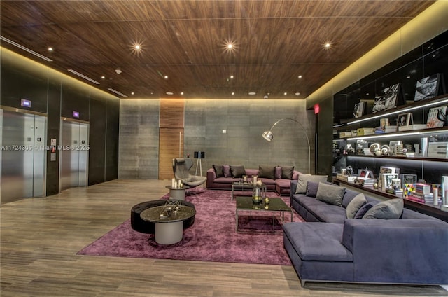 living area featuring wooden ceiling, elevator, wood finished floors, and recessed lighting