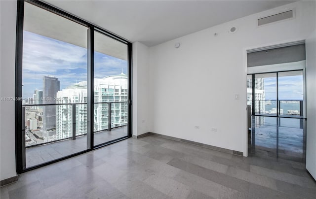 68 SE 6th St Unit 3511, Miami, FL 33131 - empty room featuring a city view and baseboards