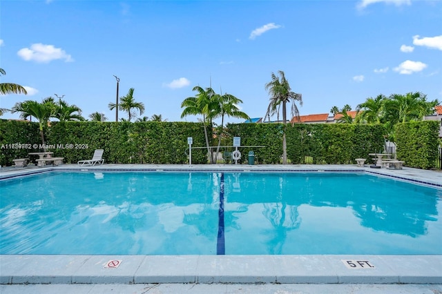 community pool featuring fence