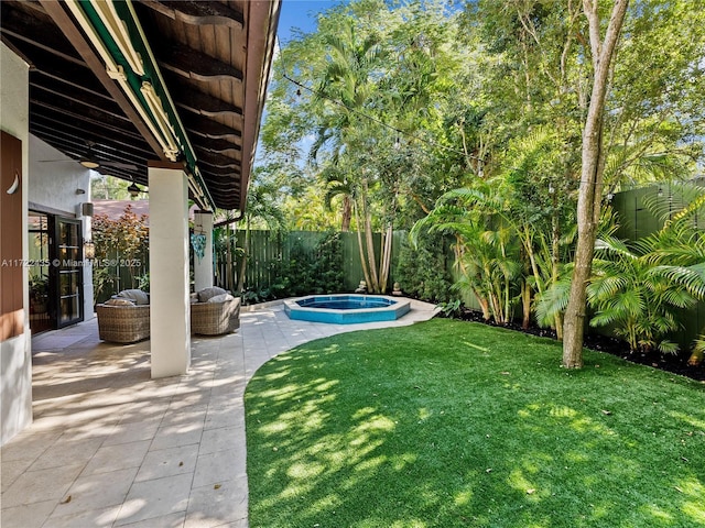 view of yard with an in ground hot tub and a patio