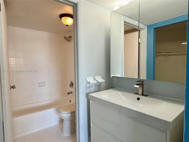 bathroom with bathing tub / shower combination, vanity, and toilet