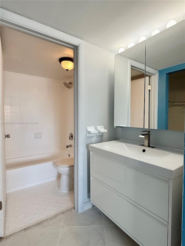 full bath featuring vanity, bathtub / shower combination, toilet, and marble finish floor
