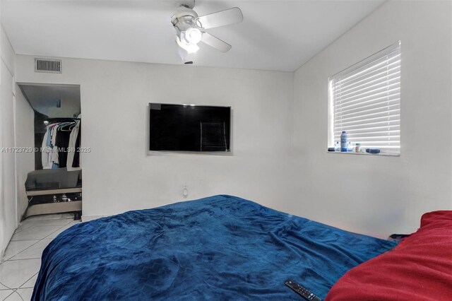 tiled bedroom with visible vents and ceiling fan