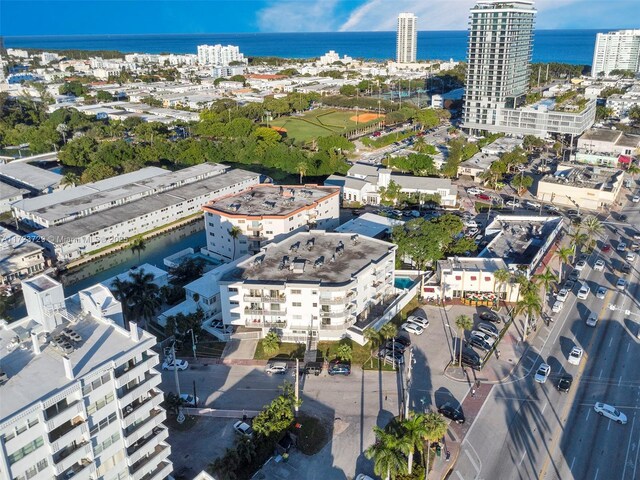 birds eye view of property with a water view and a view of city