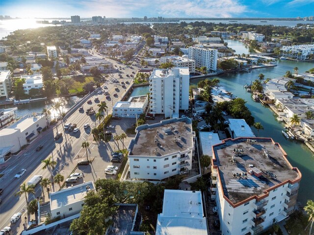 drone / aerial view featuring a view of city and a water view