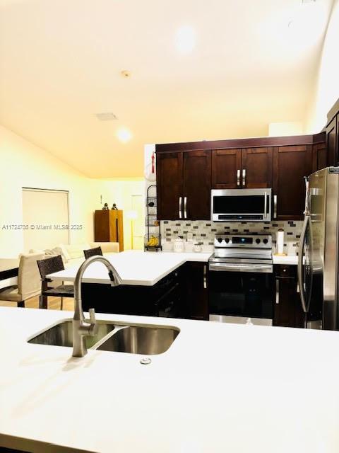 4357 Magnolia Ridge Dr, Weston, FL 33331 - kitchen with appliances with stainless steel finishes, a sink, light countertops, tasteful backsplash, and vaulted ceiling