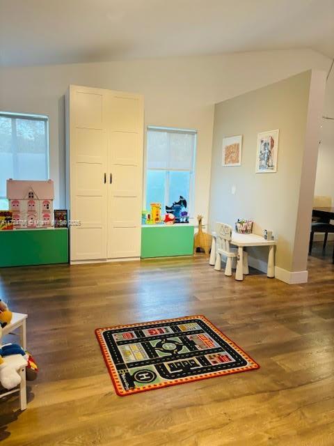 playroom featuring baseboards and wood finished floors