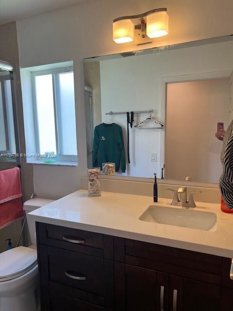 full bathroom with toilet and vanity