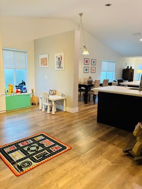 4357 Magnolia Ridge Dr, Weston, FL 33331 - living room featuring lofted ceiling, light wood finished floors, and baseboards
