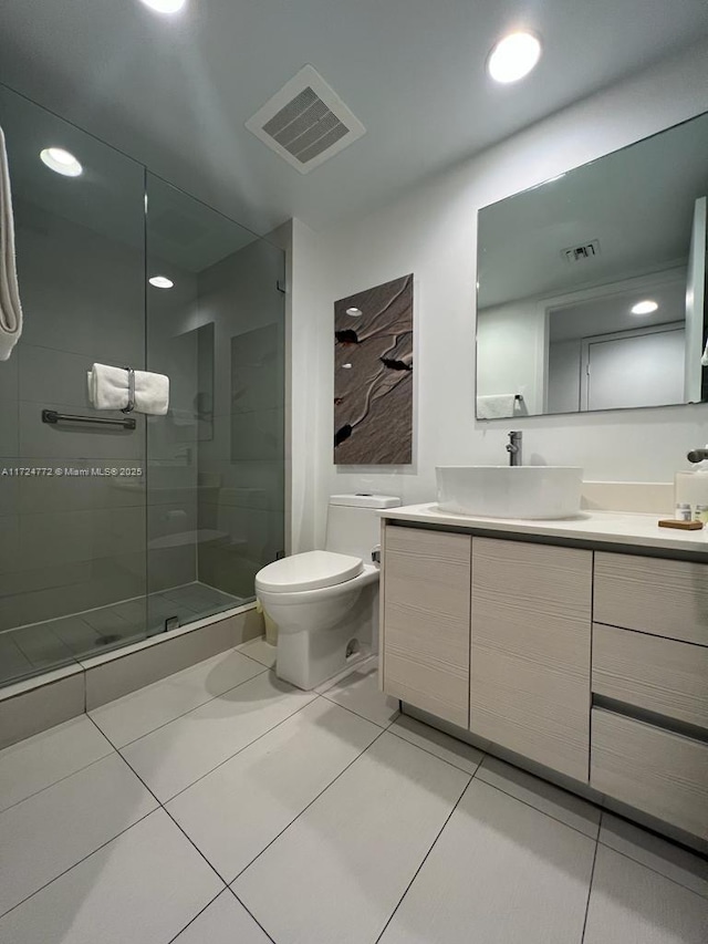 bathroom featuring tile patterned floors, vanity, toilet, and walk in shower