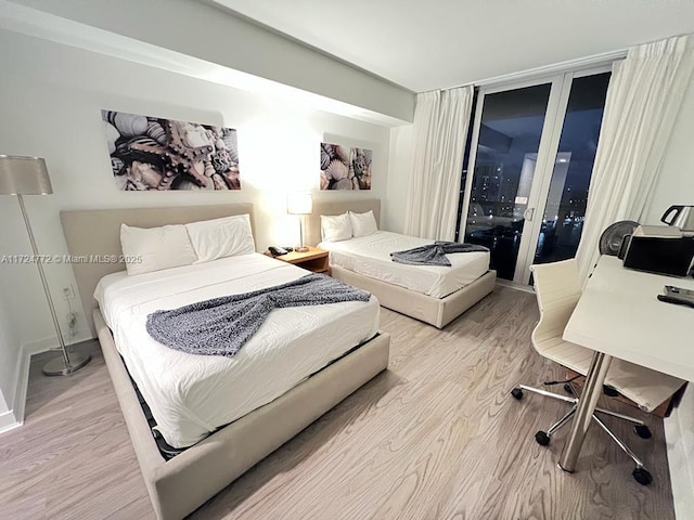 bedroom featuring access to outside and light hardwood / wood-style floors