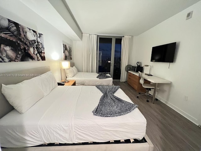 bedroom featuring access to exterior and dark hardwood / wood-style floors