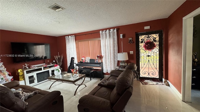 living area featuring visible vents and a textured ceiling