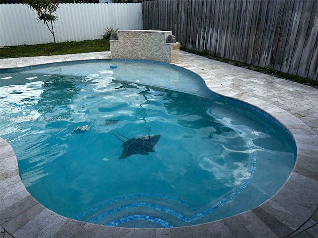 view of swimming pool with a fenced backyard, a jacuzzi, and a fenced in pool