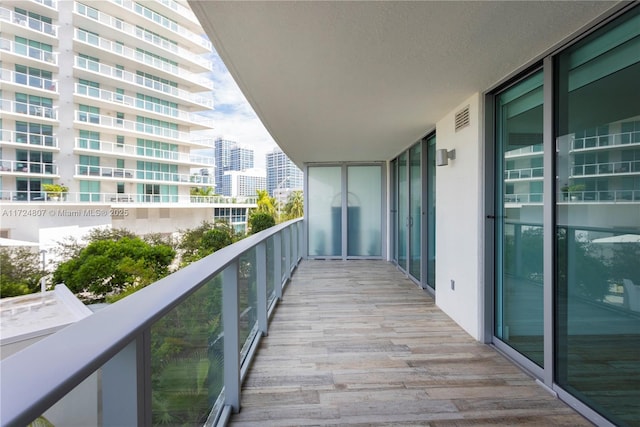 balcony featuring visible vents and a city view