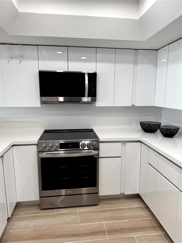 kitchen with white cabinetry and stainless steel appliances