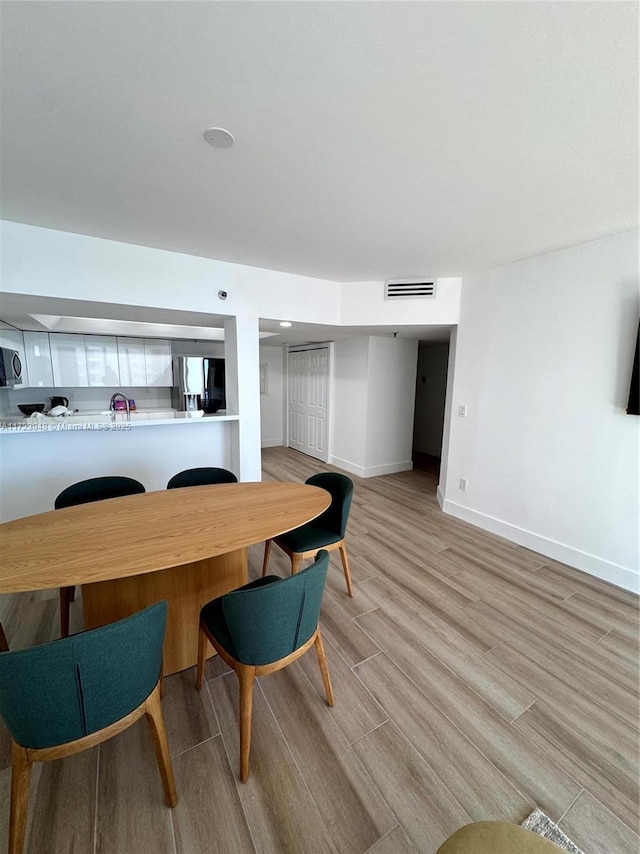 dining room with light hardwood / wood-style flooring