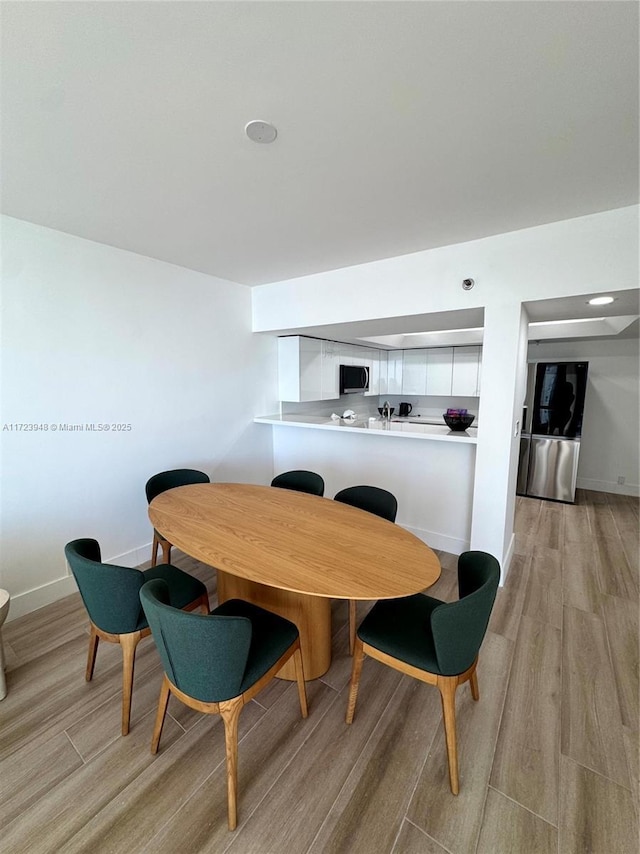 dining area with light wood-type flooring