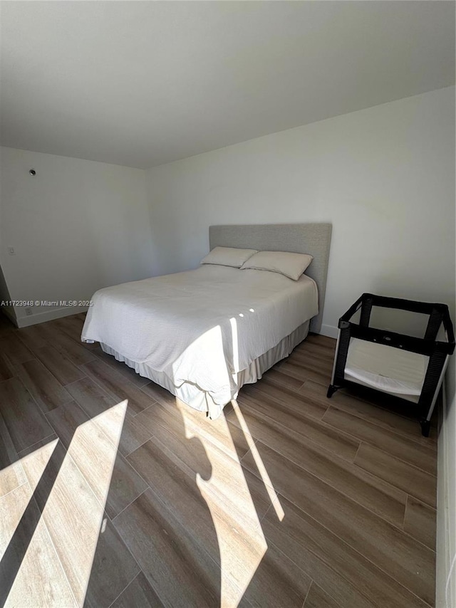 bedroom featuring dark hardwood / wood-style floors