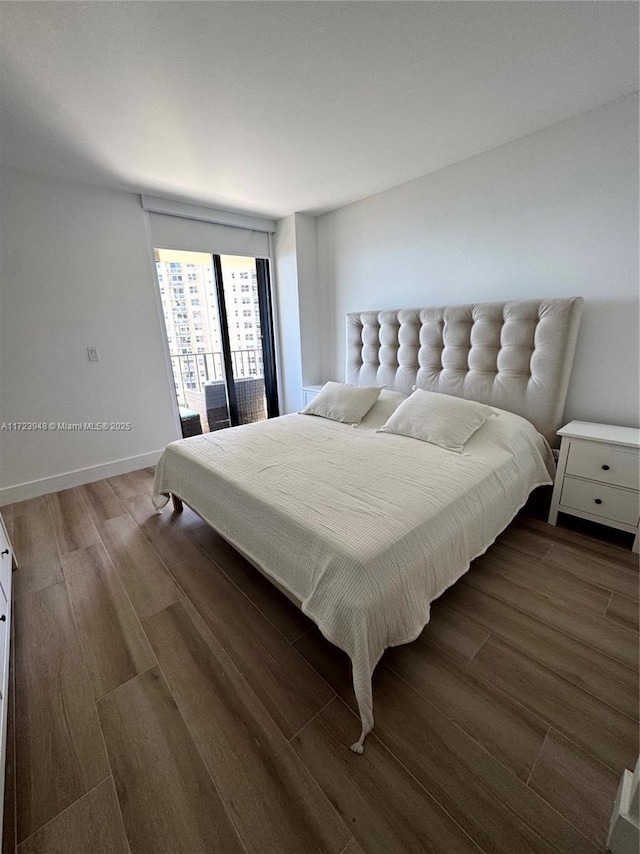 bedroom with dark hardwood / wood-style flooring