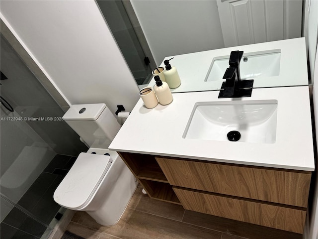 bathroom featuring a shower, vanity, and toilet