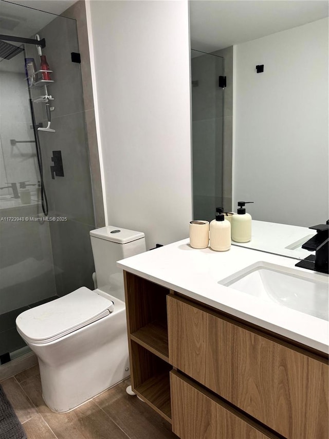 bathroom featuring vanity, an enclosed shower, and toilet