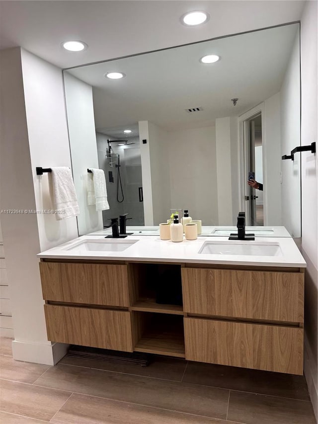 bathroom featuring vanity and a shower