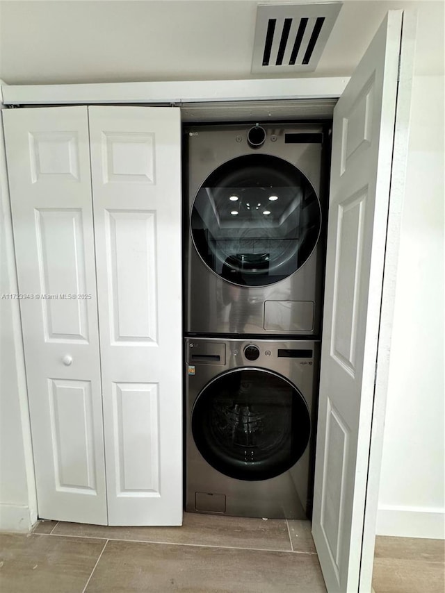 clothes washing area with stacked washer / drying machine