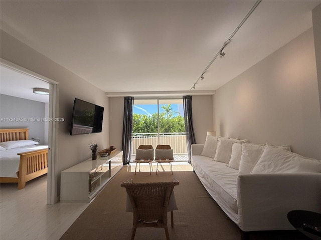 living room with hardwood / wood-style floors and track lighting