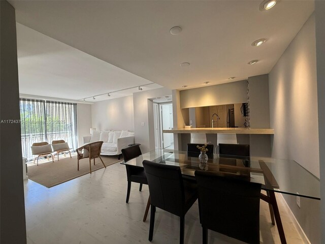 dining area featuring rail lighting