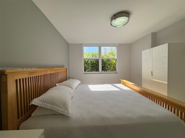 bedroom featuring vaulted ceiling