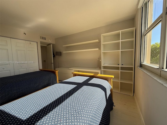 bedroom featuring a closet and light hardwood / wood-style flooring