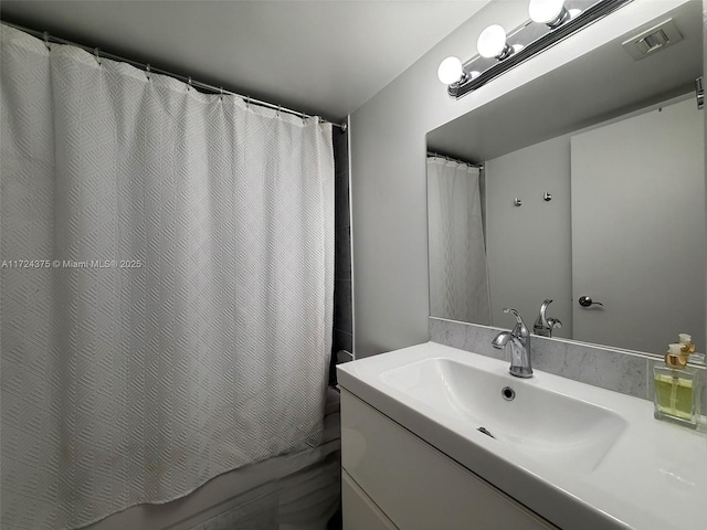 bathroom featuring vanity and a shower with shower curtain