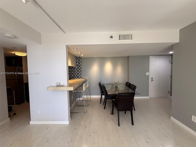 dining area featuring light wood-type flooring