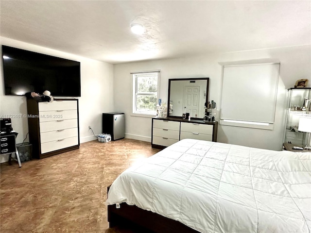 bedroom featuring stainless steel fridge