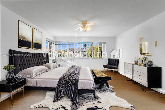 bedroom with ceiling fan and baseboards