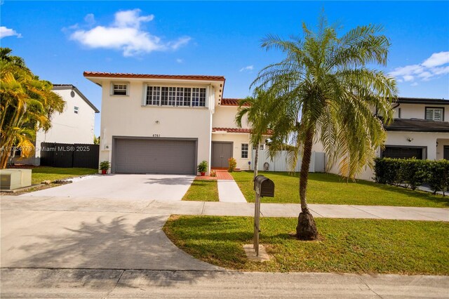 mediterranean / spanish house with a garage and a front lawn