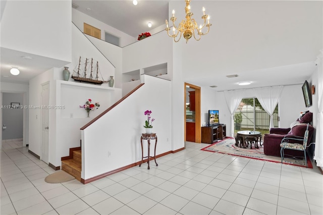 interior space featuring baseboards, visible vents, a high ceiling, and tile patterned floors